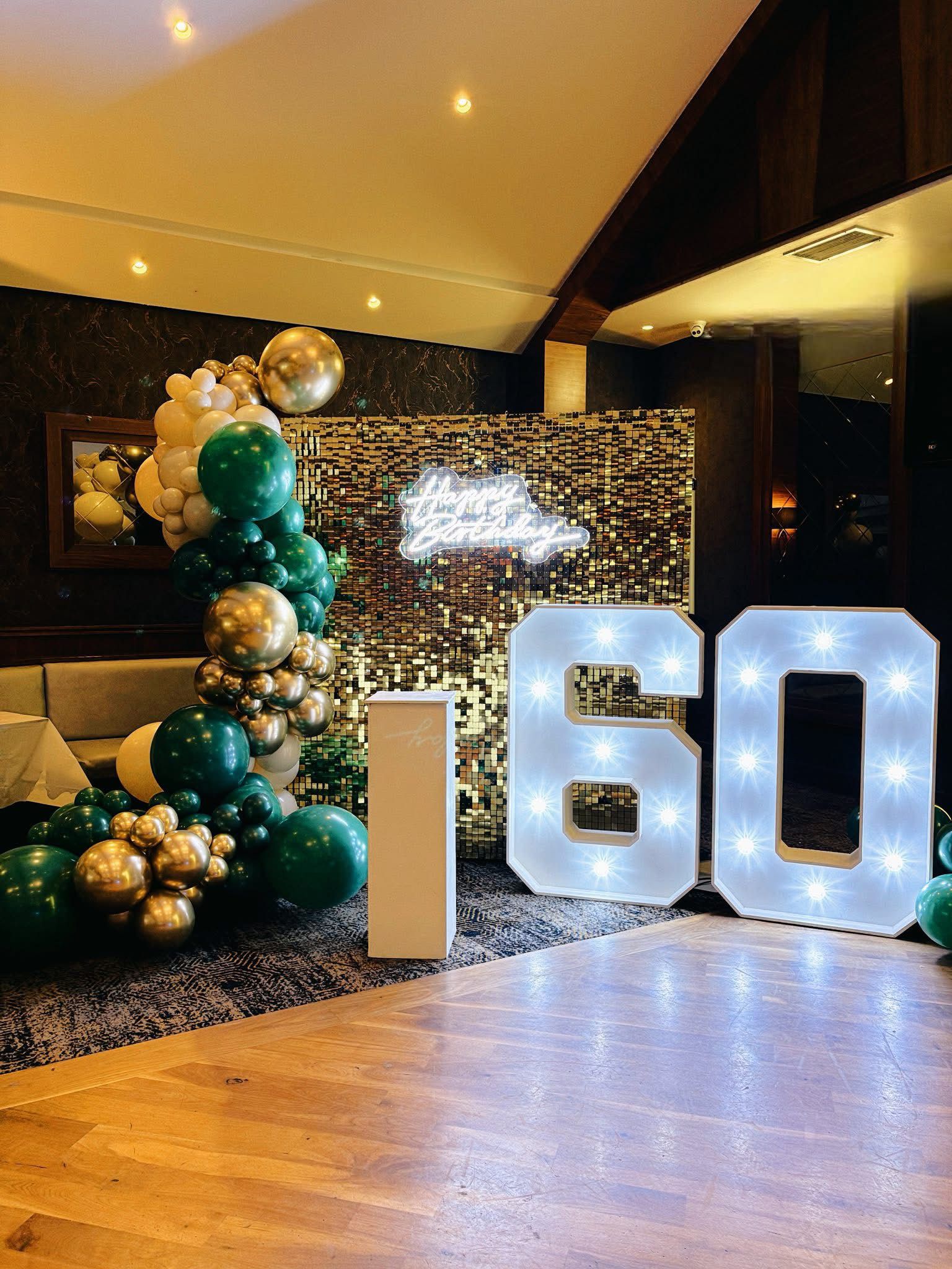 60th birthday green and gold shimmer wall with balloon column