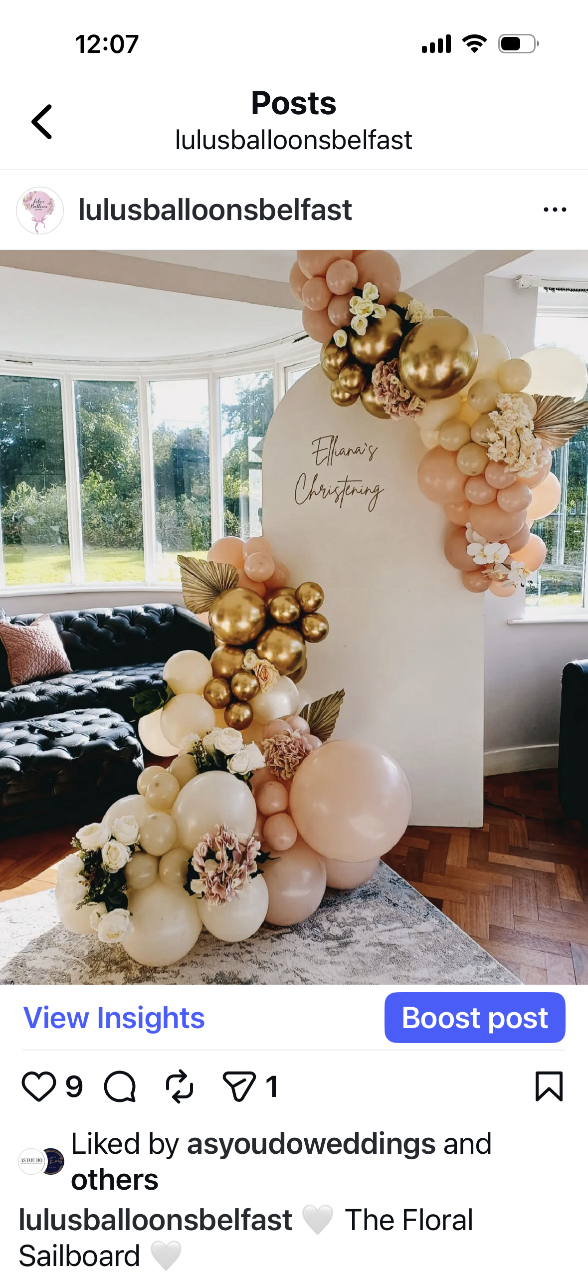 Elliana's Christening floral sailboard with peach and gold balloon arch
