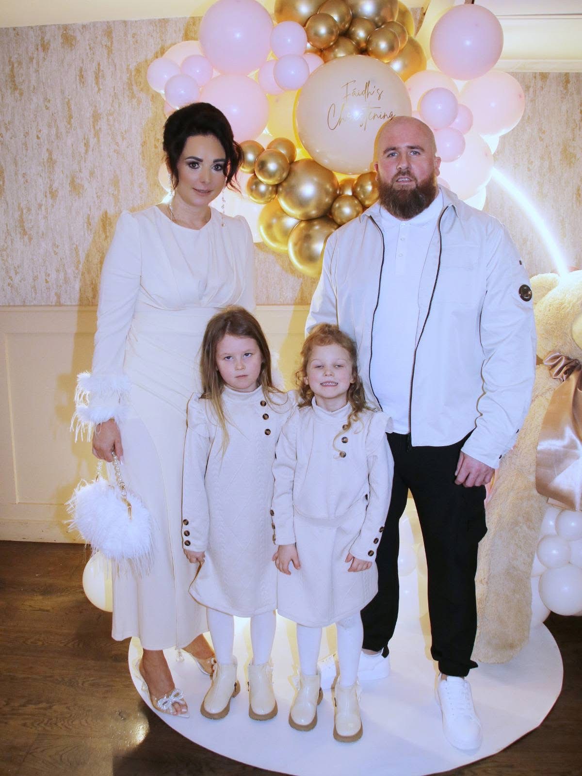 Family Christening celebration with pink and gold balloon display
