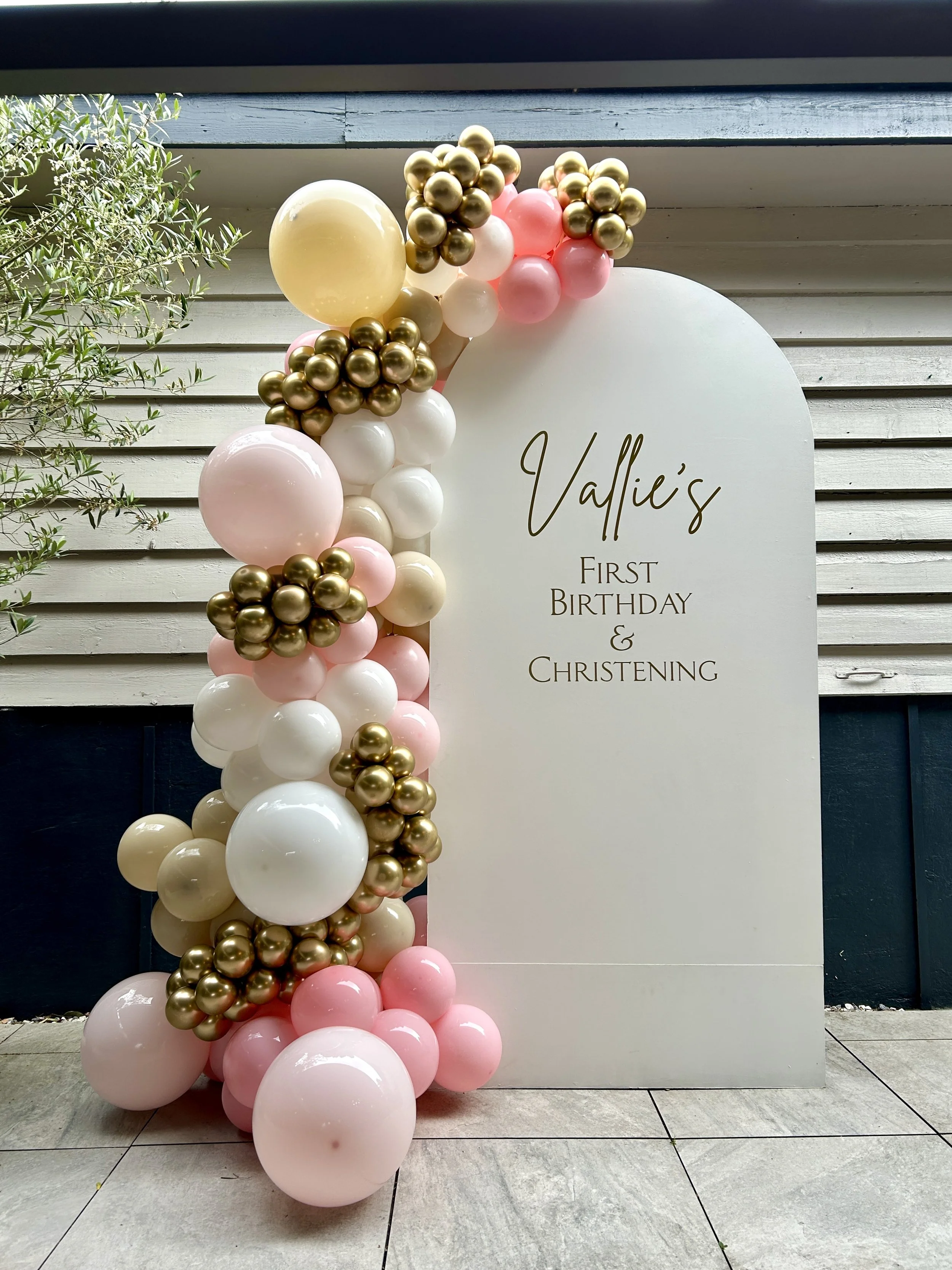Elegant pastel balloon arch Christening setup